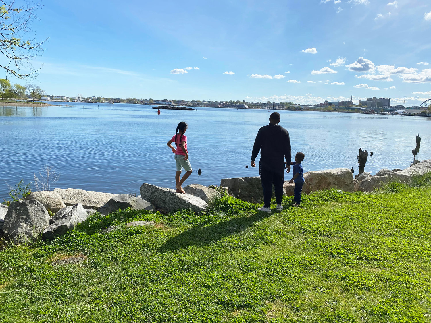 A family enjoys the late afternoon at India Point Park in Providence, at the edge of Narragansett Bay.